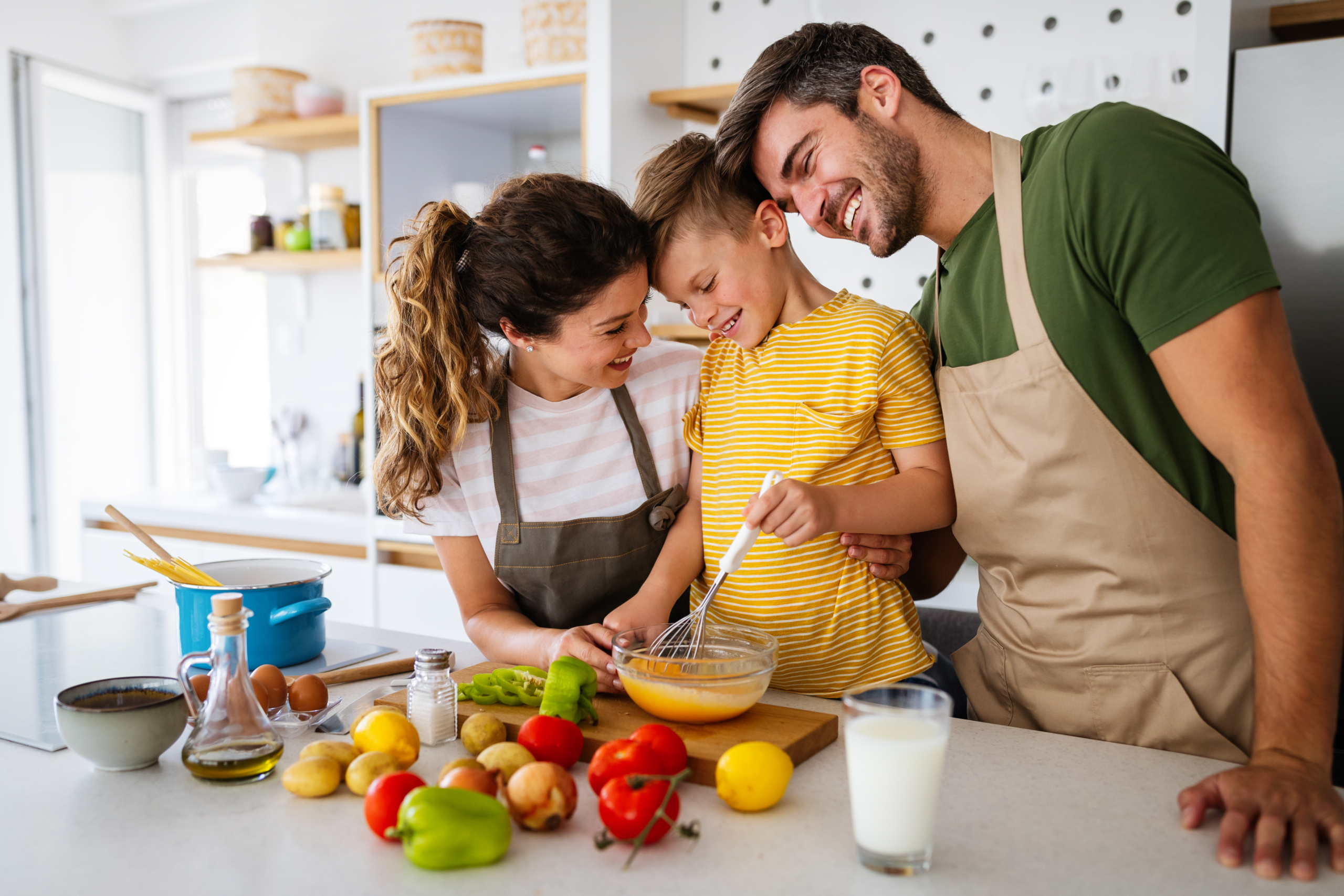 Happy family preparing healthy food together in kitchen